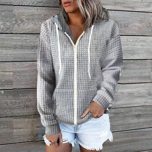 Detail view of women's grey waffle texture zip-up hoodie with white drawstring hood