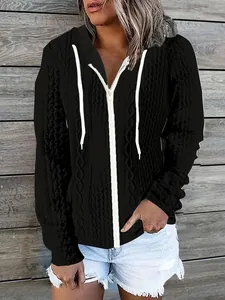 Detailed view of women's black zip-up hoodie with cable-knit jacquard texture