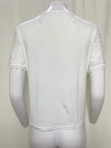 Detailed back view of a stylish white T-shirt with intricate floral lace short sleeves.