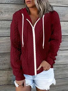 Close-up detail of a women's burgundy casual zip-up hoodie with cable knit texture
