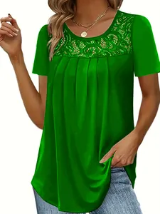 Close-up of green women's top with intricate lace neckline and pleated detail.