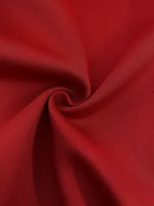 Detailed macro view of the premium red fabric texture for a women's fashion blazer suit.