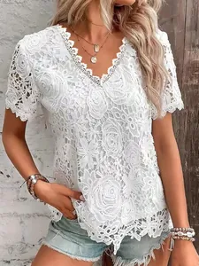 Detailed view of elegant white floral lace short sleeve top featuring intricate rose patterns