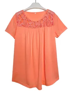 Close-up of peach short-sleeve t-shirt featuring intricate lace neckline detailing.