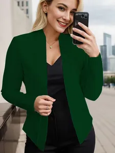 Close-up of a stylish dark green open-front blazer jacket worn in an urban outdoor setting
