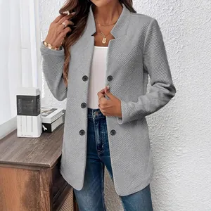 Detailed view of grey stand-collar cardigan with quilted texture and button closure
