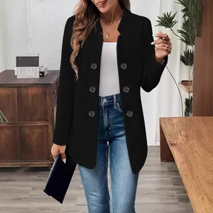Close-up of black standing collar cardigan coat with double-breasted button details.
