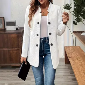 Detail shot of white textured coat featuring stand collar and stylish black buttons.