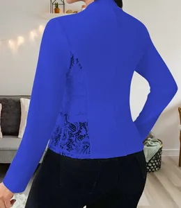 Detail of royal blue blazer featuring elegant floral lace patchwork on the back.