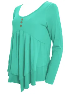 Detailed view of turquoise long-sleeve top with three wooden buttons and pleated layered hem