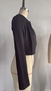 Side profile detail of a slim-fit black cropped long-sleeve jacket on a mannequin