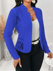 Detail shot of elegant women's blue slim-fit blazer featuring side floral lace panels