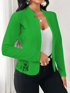 Close-up detail of a bright green blazer featuring elegant side lace patchwork panels.