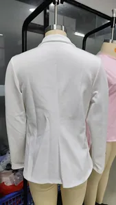 Detailed back view of a sleek white long-sleeved tailored blazer on a mannequin.