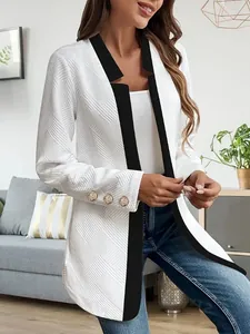 Detail of women's textured blazer with contrast black trim and gold sleeve buttons
