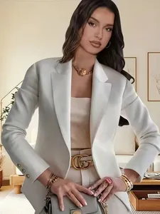 Detail view of women's white long sleeve lapel blazer with elegant cufflink accents.