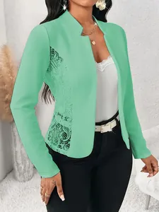 Detailed view of an elegant mint green slim blazer featuring intricate lace patchwork panels