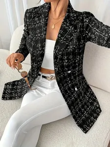 Close-up detail of black and white tweed slim fit blazer with button accents
