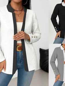 Elegant textured color-block blazer featuring decorative gold sleeve buttons in white and black