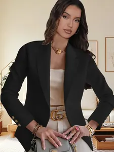 Close-up of elegant black long-sleeve women's blazer featuring classic lapels and metal buttons.