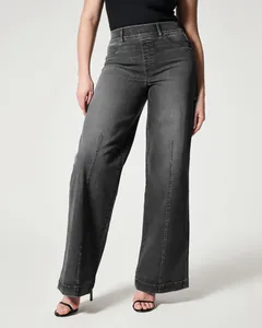 Detail showing the wide-leg cut and washed grey texture of elastic waist denim jeans
