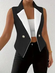 Close-up of sleeveless black vest with white contrast lapel and gold buttons