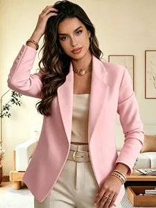 Fashionable woman wearing pink long sleeve blazer with gold button cuffs detail