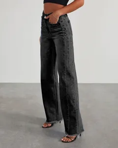 Detailed view of women's black wide-leg jeans with side-seam paneling and frayed hem