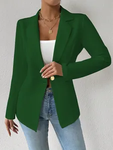 Gedetailleerde weergave van een donkergroene blazer met een gouden knoopsluiting