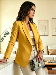 Detail view of an elegant mustard yellow blazer with three cuff buttons for women