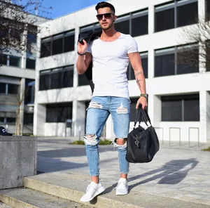 Stylish light blue ripped skinny jeans for men featuring a distressed knee detail
