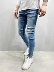 Detail view of men's light blue stretch skinny jeans showing the slim fit silhouette