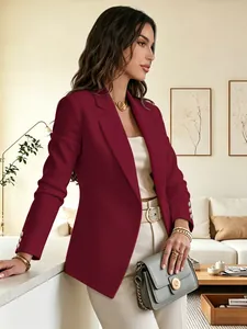 Detail of a burgundy women's blazer with notched lapels and decorative sleeve buttons