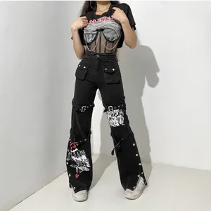 Streetwear black denim pants featuring metal buckles, studs, and graphic prints
