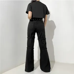 Detailed back view of street-style black denim wide-leg pants with metal eyelet straps.