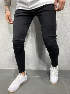 Detail view of men's black skinny stretch denim jeans showing slim fit and texture.