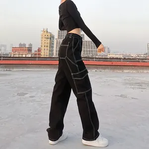 Black high waist cargo pants with contrast white stitching for street fashion style.