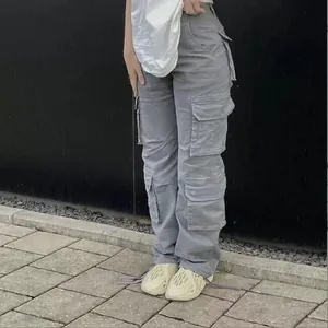 Close-up of high-waisted grey cargo jeans with vintage loose fit and side pockets