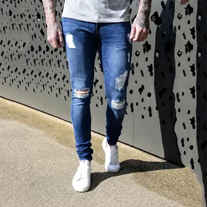 Stylish men's blue distressed skinny jeans featuring ripped knees and a vintage faded wash finish
