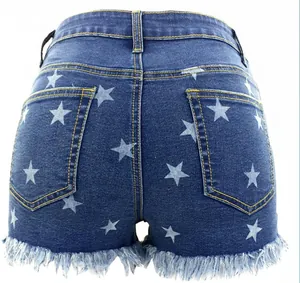 Detailed back view of high-waisted denim shorts with star print and fringe hem