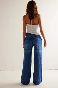 Back view of stylish loose wide-leg blue denim jeans with elastic waist and back pockets