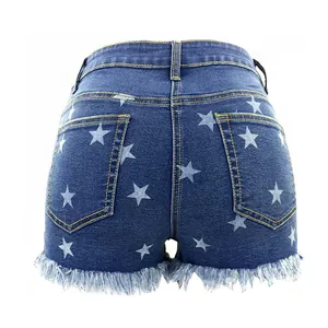 Stylish women's high waisted denim shorts featuring white star prints and frayed fringe hem detail