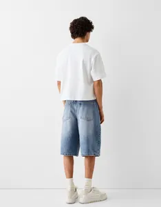 Detailed back view of loose-fit men's denim shorts in a light wash blue denim fabric.