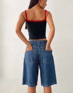 Back view showing the fit and pockets of women's slim blue denim bermuda shorts.