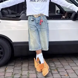 American vintage washed denim shorts featuring a wide leg and distressed street style design