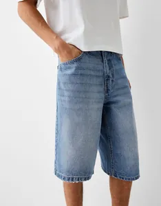 Detail shot of men's relaxed fit denim shorts featuring a light blue vintage wash