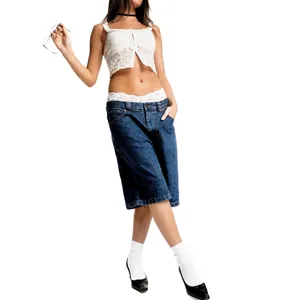 Stylish blue denim bermuda shorts for women with chic white lace top detail view.