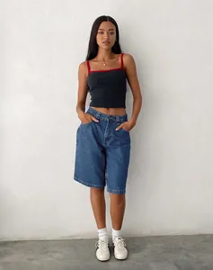 Full body shot of the model showcasing the fit and length of the blue denim shorts
