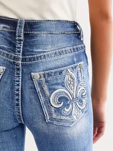 Detailansicht der Damen-Denim-Jeans mit Fleur-de-Lis-Stickerei auf der Gesäßtasche