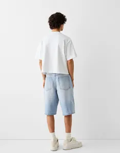 Detailed back view of men's light blue washed denim shorts featuring two rear pockets